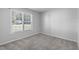 Neutral bedroom featuring a window with outside view and plush carpeting at 318 Duck Pond Ln, Clayton, NC 27520