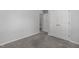 Bedroom showcasing closet with doors, light-gray walls, plush carpeting, and natural light at 318 Duck Pond Ln, Clayton, NC 27520