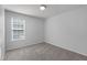 Neutral bedroom featuring a window with outside view and plush carpeting at 318 Duck Pond Ln, Clayton, NC 27520