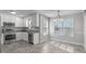 Cozy dining area with natural light, stainless appliances, and white cabinets at 318 Duck Pond Ln, Clayton, NC 27520