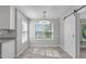 Bright dining area featuring natural light, a sliding barn door, and an elegant light fixture at 318 Duck Pond Ln, Clayton, NC 27520