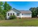 Charming home exterior with white siding, well-kept lawn, and lush green trees in a serene and tranquil setting at 318 Duck Pond Ln, Clayton, NC 27520