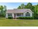 Charming single-story home featuring green shutters and manicured front yard shrubbery at 318 Duck Pond Ln, Clayton, NC 27520