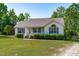 Attractive one-story home showcasing a well-manicured lawn and established landscaping at 318 Duck Pond Ln, Clayton, NC 27520