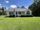 Charming single-story home with manicured lawn, complemented by a quaint front porch and verdant shrubbery at 318 Duck Pond Ln, Clayton, NC 27520