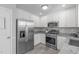 Charming kitchen with stainless steel appliances, granite counters, and ample cabinet space at 318 Duck Pond Ln, Clayton, NC 27520