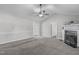 Open living room with a ceiling fan, fireplace, and neutral paint scheme at 318 Duck Pond Ln, Clayton, NC 27520
