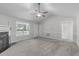 Bright living room featuring neutral carpet, a fireplace, and a window at 318 Duck Pond Ln, Clayton, NC 27520