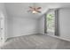 Spacious main bedroom with a vaulted ceiling, ceiling fan, and a large window at 318 Duck Pond Ln, Clayton, NC 27520