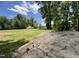 Large grassy yard with storage shed and rock feature at 318 Duck Pond Ln, Clayton, NC 27520