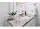 Bathroom vanity with granite countertop, a mirror, white cabinetry, and decorative accents at 3209 Bryant Falls Ct, Raleigh, NC 27613