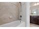Bathroom features a tub and shower with tiled walls and dark cabinets at 3209 Bryant Falls Ct, Raleigh, NC 27613