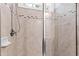 Tiled shower stall with a glass door features decorative tile insets and a showerhead at 3209 Bryant Falls Ct, Raleigh, NC 27613