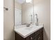 Bathroom featuring a single sink vanity with a white countertop, dark cabinets and a large mirror at 3209 Bryant Falls Ct, Raleigh, NC 27613