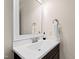 Bathroom vanity with a white countertop, framed mirror, and dark wood cabinetry at 3209 Bryant Falls Ct, Raleigh, NC 27613