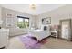 Bright bedroom with colorful rug, decorative mirror, and large window at 3209 Bryant Falls Ct, Raleigh, NC 27613