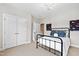 Bedroom with white doors and trim, a black metal bed frame and neutral carpet at 3209 Bryant Falls Ct, Raleigh, NC 27613