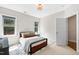 Well-lit bedroom featuring a bed with stylish pillows and a geometric patterned rug at 3209 Bryant Falls Ct, Raleigh, NC 27613