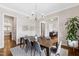 Formal dining room with a wooden table, seating for six, a modern chandelier, and hardwood floors at 3209 Bryant Falls Ct, Raleigh, NC 27613