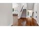 Inviting entryway with hardwood floors, staircase, and view into a bedroom featuring neutral tones and plenty of natural light at 3209 Bryant Falls Ct, Raleigh, NC 27613