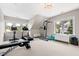 Bright exercise room featuring modern workout equipment and natural light from multiple windows at 3209 Bryant Falls Ct, Raleigh, NC 27613