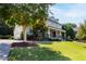Spacious home with a multi-car garage, covered porch, manicured lawn, and mature trees at 3209 Bryant Falls Ct, Raleigh, NC 27613