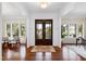 Bright foyer featuring gleaming hardwood floors and beautiful double doors at 3209 Bryant Falls Ct, Raleigh, NC 27613