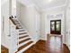 Elegant foyer showcasing staircase, hardwood floors, and front door at 3209 Bryant Falls Ct, Raleigh, NC 27613