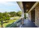 Inviting front porch with stone accents and black railing overlooking a beautifully landscaped front yard at 3209 Bryant Falls Ct, Raleigh, NC 27613