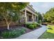 Charming stone-accented front porch with elegant columns and professional landscaping along walkway at 3209 Bryant Falls Ct, Raleigh, NC 27613
