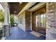 Charming front porch featuring stone columns, dark wood double doors, and a 'welcome' mat at 3209 Bryant Falls Ct, Raleigh, NC 27613