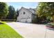 Multi-car garage with ample parking space and a well-manicured lawn surrounded by mature trees at 3209 Bryant Falls Ct, Raleigh, NC 27613