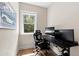 Well-lit home office featuring a modern desk setup, comfortable chair, and natural light at 3209 Bryant Falls Ct, Raleigh, NC 27613