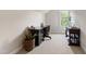 Bright home office with a view, featuring a wooden desk and natural light at 3209 Bryant Falls Ct, Raleigh, NC 27613