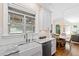 Kitchen featuring farmhouse sink, granite counters, and window with backyard views at 3209 Bryant Falls Ct, Raleigh, NC 27613