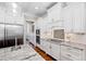 Gourmet kitchen with stainless steel appliances, granite countertops, white cabinets, and subway tile backsplash at 3209 Bryant Falls Ct, Raleigh, NC 27613