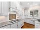 Bright and modern kitchen featuring white cabinets, granite countertops, subway tile backsplash and stainless appliances at 3209 Bryant Falls Ct, Raleigh, NC 27613