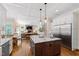 Large open kitchen with stainless appliances, wood floors, granite counters, and eat-in dining area at 3209 Bryant Falls Ct, Raleigh, NC 27613