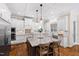 Spacious kitchen island with granite countertops, a pendant light, and white cabinetry at 3209 Bryant Falls Ct, Raleigh, NC 27613