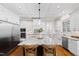 Large kitchen island with seating, granite countertops, a pendant light, and white cabinetry at 3209 Bryant Falls Ct, Raleigh, NC 27613