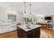 Island sink with stainless faucet in an open kitchen with granite countertops, and a dark wood island base at 3209 Bryant Falls Ct, Raleigh, NC 27613
