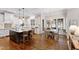 Open kitchen and breakfast area featuring hardwood floors, an island with seating, and natural light at 3209 Bryant Falls Ct, Raleigh, NC 27613