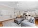 Bright living room with coffered ceiling, open to kitchen, and comfortable seating at 3209 Bryant Falls Ct, Raleigh, NC 27613
