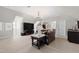Open-concept living room with a large sectional sofa, modern lighting, and a stylish entertainment area at 3209 Bryant Falls Ct, Raleigh, NC 27613