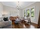 Bright and airy living room with a modern chandelier and hardwood floors at 3209 Bryant Falls Ct, Raleigh, NC 27613