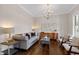 Comfortable living room featuring a stylish sofa, modern chandelier, and hardwood floors at 3209 Bryant Falls Ct, Raleigh, NC 27613