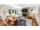 Cozy living room with a stone fireplace, large windows, and comfortable seating at 3209 Bryant Falls Ct, Raleigh, NC 27613