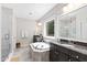 This main bathroom features a soaking tub, glass-enclosed shower, dual sinks, vanity lighting, and neutral tones at 3209 Bryant Falls Ct, Raleigh, NC 27613