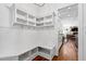 Mudroom with built-in storage, coat hooks, a bench with shelves, and hardwood floors at 3209 Bryant Falls Ct, Raleigh, NC 27613