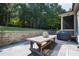 Outdoor patio features a dining table, grill, and a beautiful view of the yard at 3209 Bryant Falls Ct, Raleigh, NC 27613